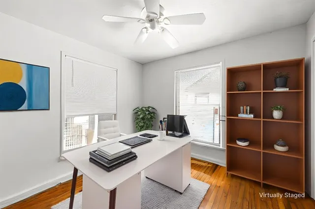 a living room with furniture a rug and white walls