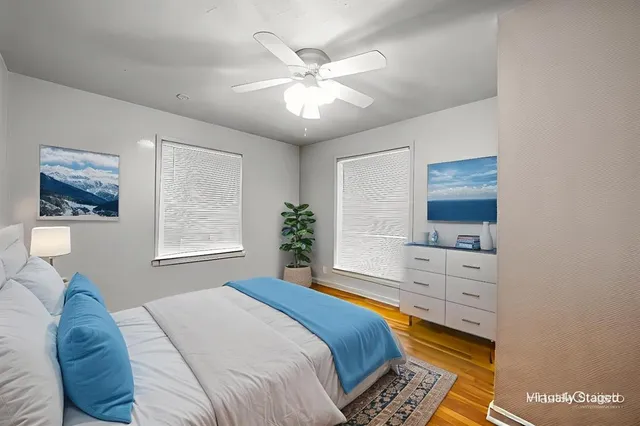 a bedroom with a large bed and a window