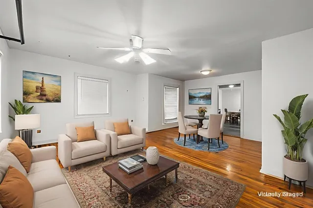 a living room with furniture potted plant and window