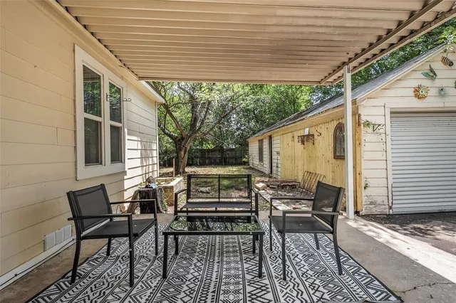 a backyard of a house with outdoor seating
