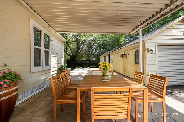 a view of a patio with table and chairs and potted plants