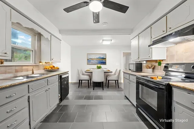 a kitchen with a sink stainless steel appliances and cabinets