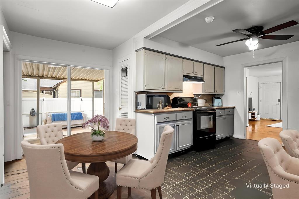 1205 Ashleman Street Bellmead, TX 76705 - Photo 10 of 33 a kitchen with stainless steel appliances granite countertop a stove a sink a microwave a dining table and chairs