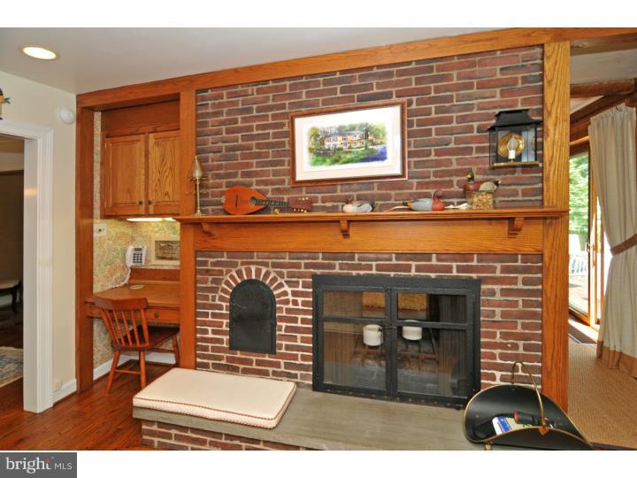 7 Andorra Hill Road Lafayette Hill, PA 19444 - Photo 13 of 23 a view of a fireplace with a table and chairs in living room