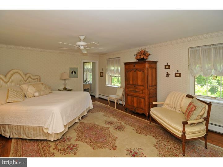 7 Andorra Hill Road Lafayette Hill, PA 19444 - Photo 15 of 23 a spacious bedroom with a bed a couch and dresser