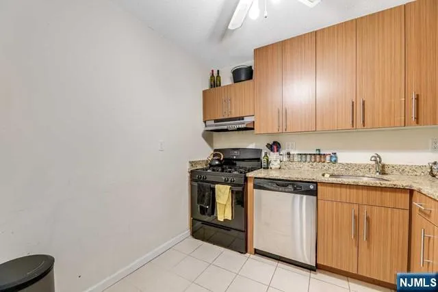 a kitchen with stainless steel appliances granite countertop a stove and a sink