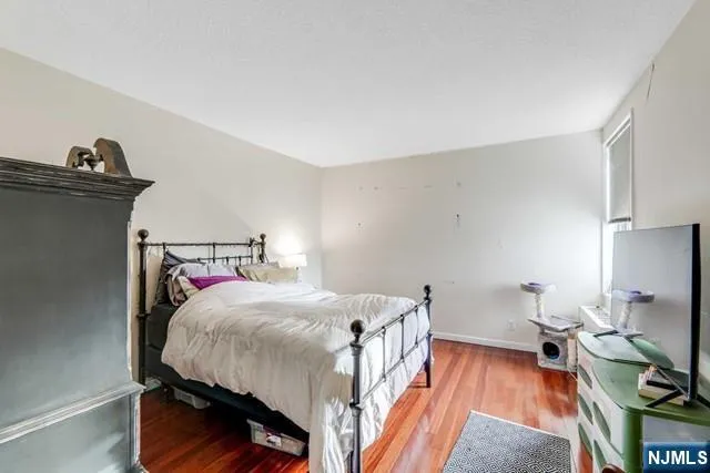 a bedroom with a bed and a tv in it