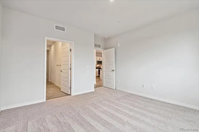 a view of an empty room and closet area