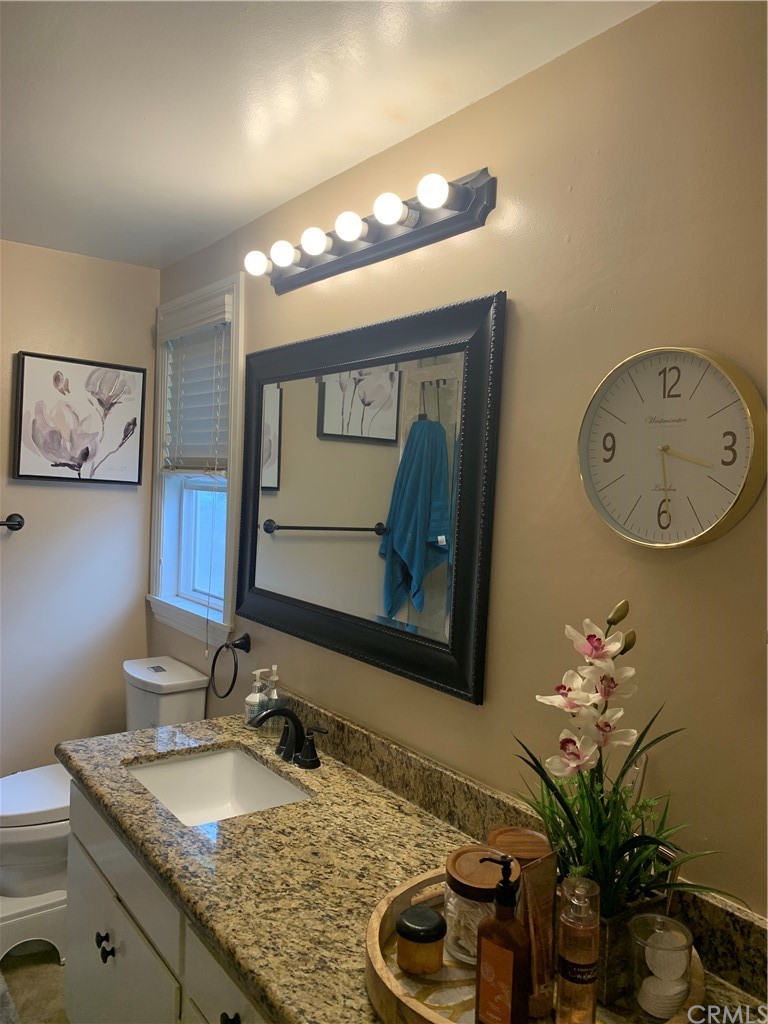 23625 Pineforest Lane Harbor City, CA 90710 - Photo 17 of 22 a bathroom with a granite countertop sink and a mirror