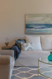 a bedroom with a bed and a lamp on dresser