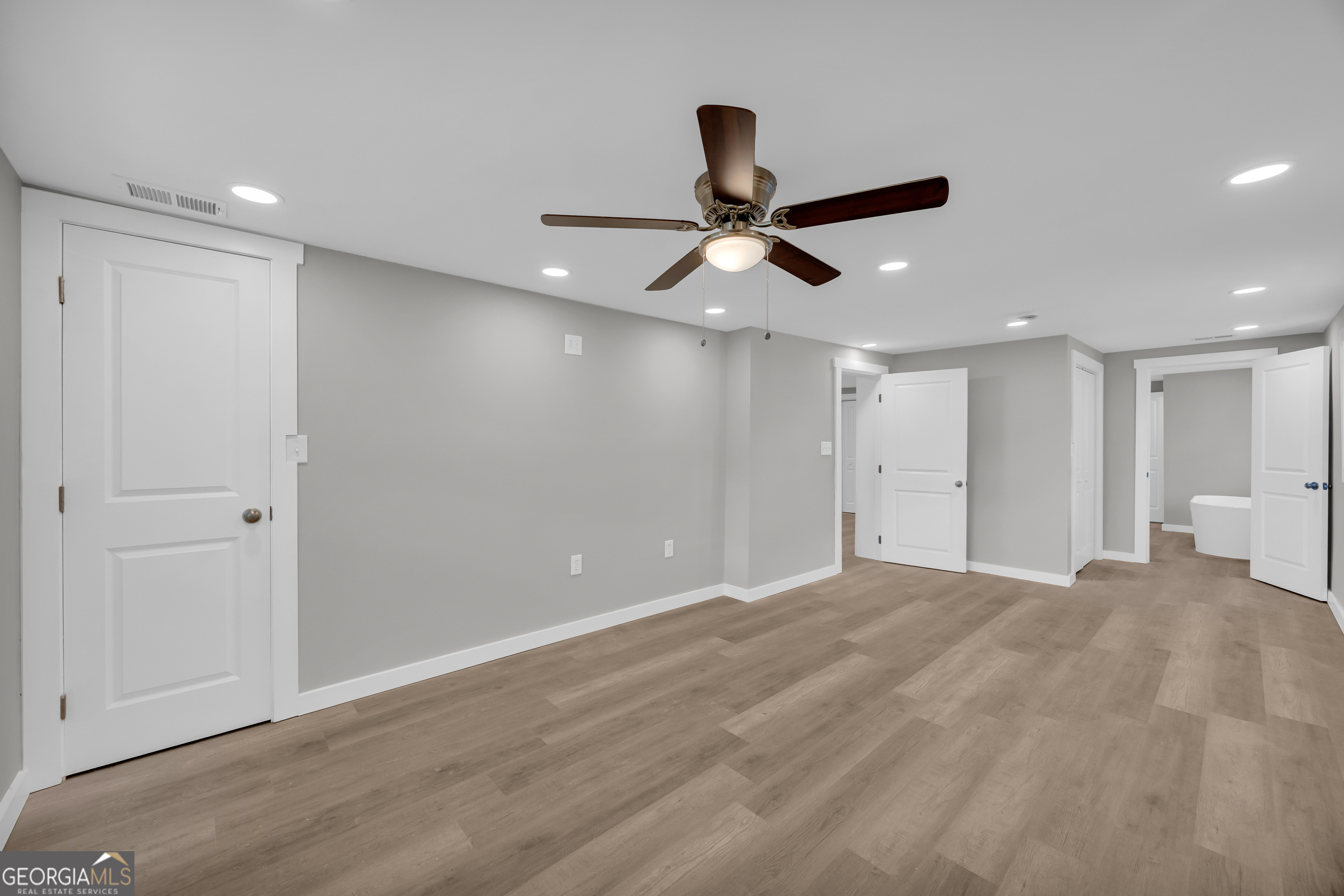 8606 Holly Springs Road Maysville, GA 30558 - Photo 43 of 74 a view of an empty room with a ceiling fan