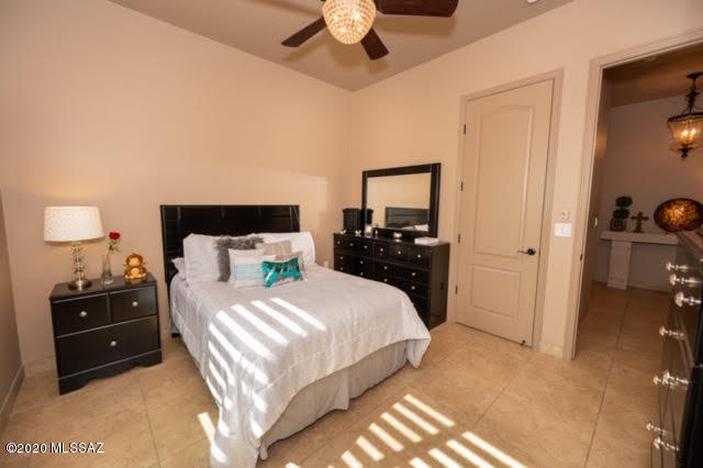 407 Camino Agua Fria Rio Rico, AZ 85648 - Photo 25 of 41 a bedroom with a bed and a chandelier