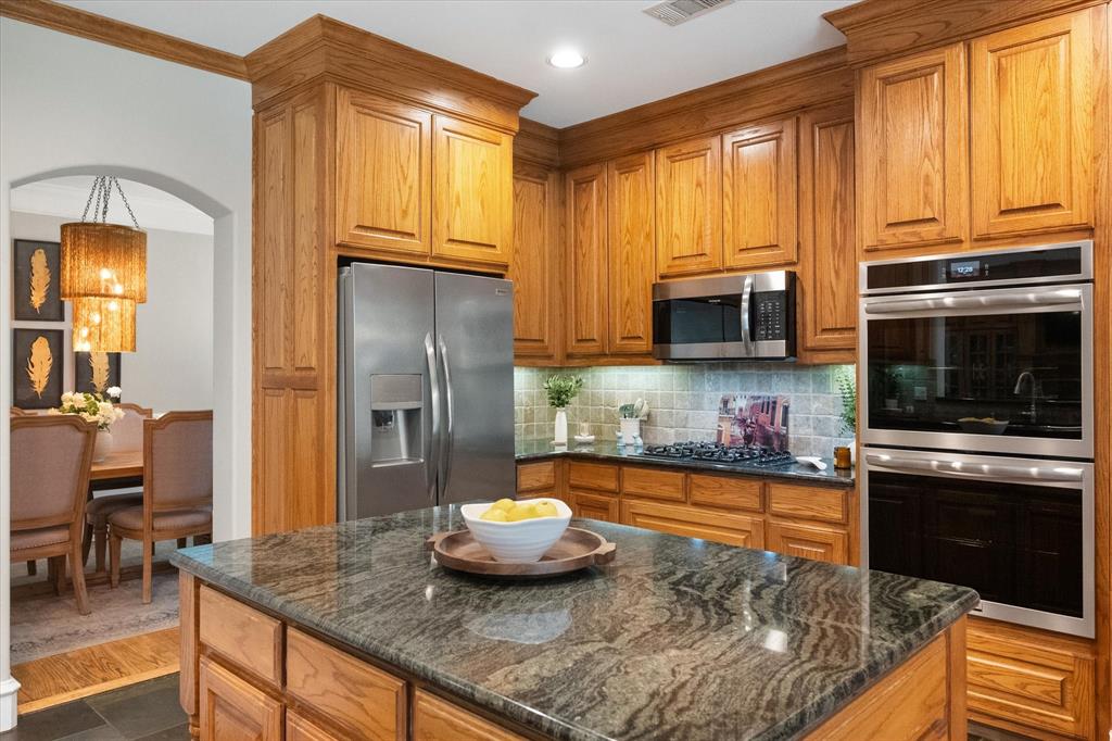 2111 Castle View Road Mansfield, TX 76063 - Photo 12 of 39 Granite countertops, lots of cabinet space, and a large island