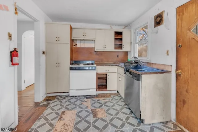 a kitchen with a refrigerator and a stove