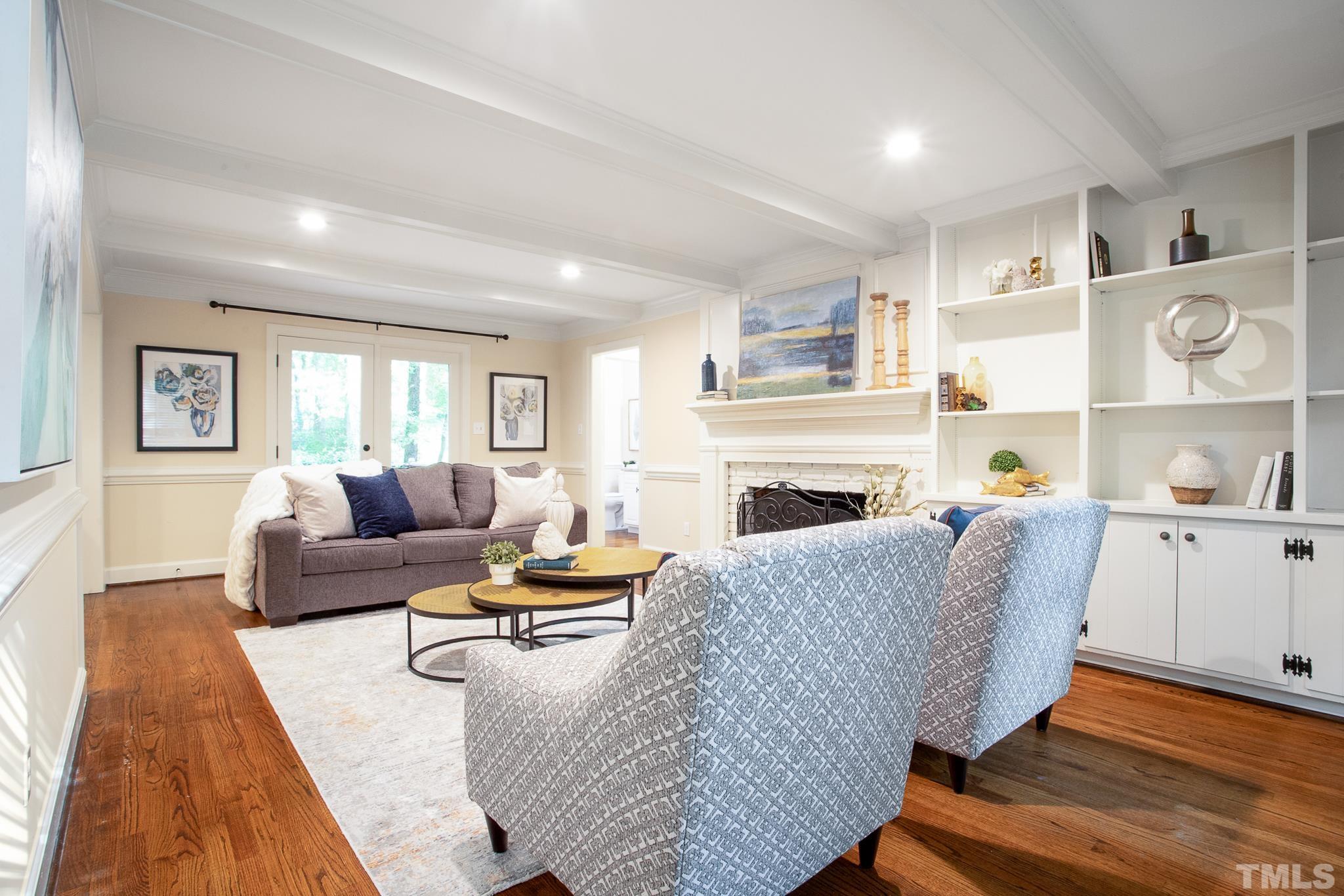7301 Tanbark Way Raleigh, NC 27615 - Photo 11 of 36 a living room with furniture fireplace and wooden floor