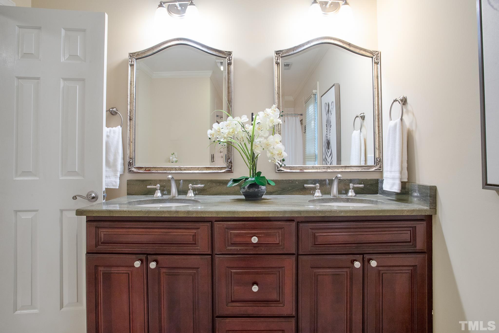 7301 Tanbark Way Raleigh, NC 27615 - Photo 28 of 36 a bathroom with a granite countertop sink and a mirror
