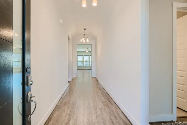 a view of a hallway with wooden floor