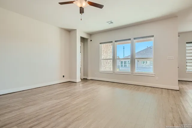 wooden floor in an empty room with a window