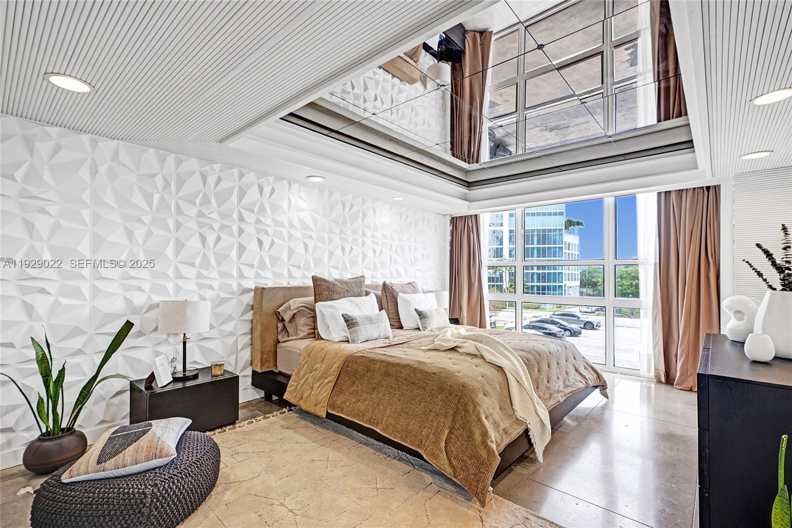 600 Northeast 36th Street, Unit 218 Miami, FL 33137 - Photo 3 of 31 a bed sitting in a bedroom next to a window