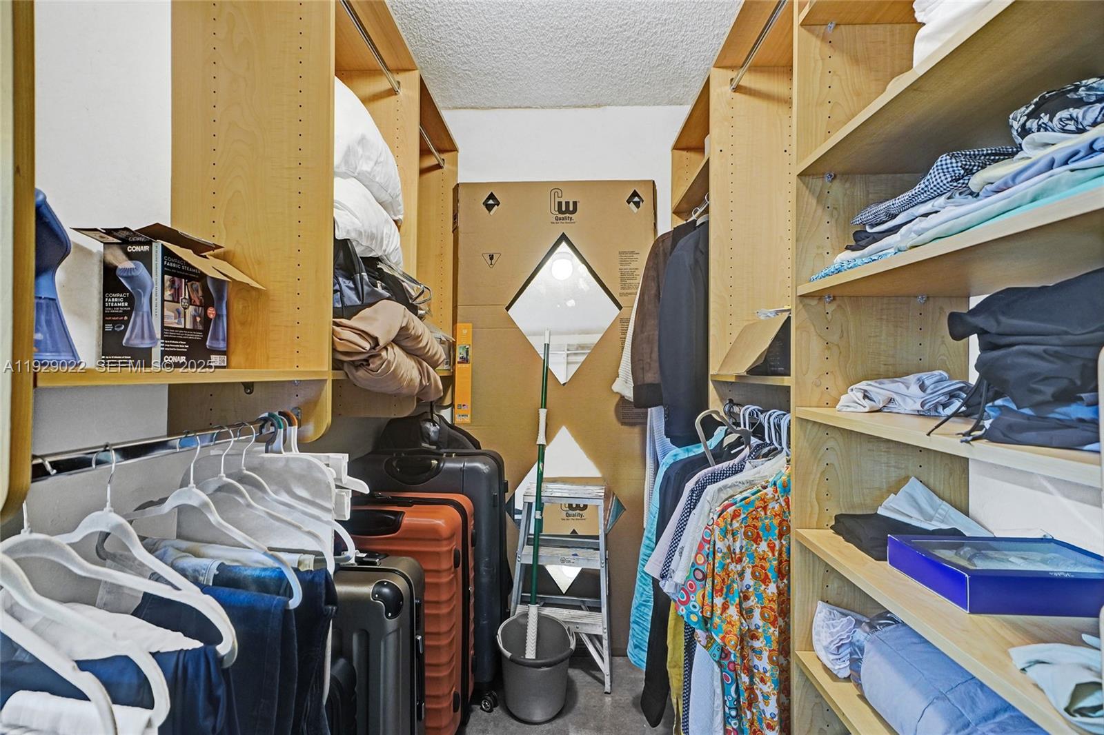 600 Northeast 36th Street, Unit 218 Miami, FL 33137 - Photo 8 of 31 a view of walk in closet with clothes and shoes