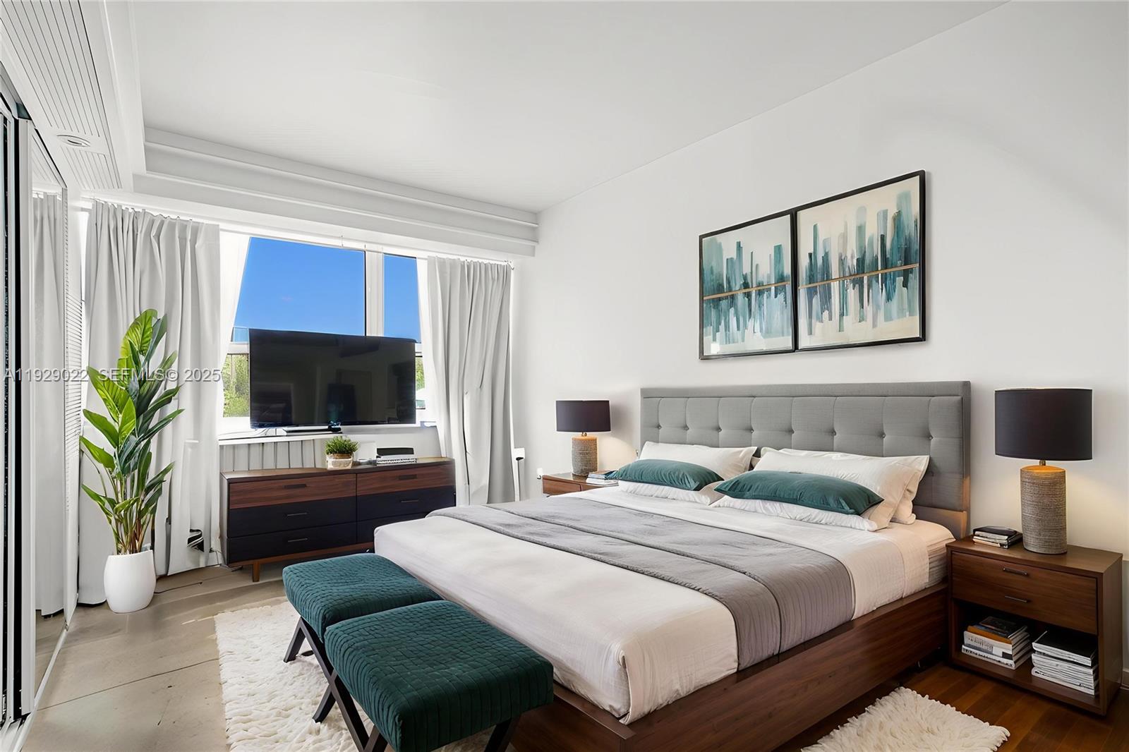 600 Northeast 36th Street, Unit 218 Miami, FL 33137 - Photo 9 of 31 a bedroom with a bed a television and a couch