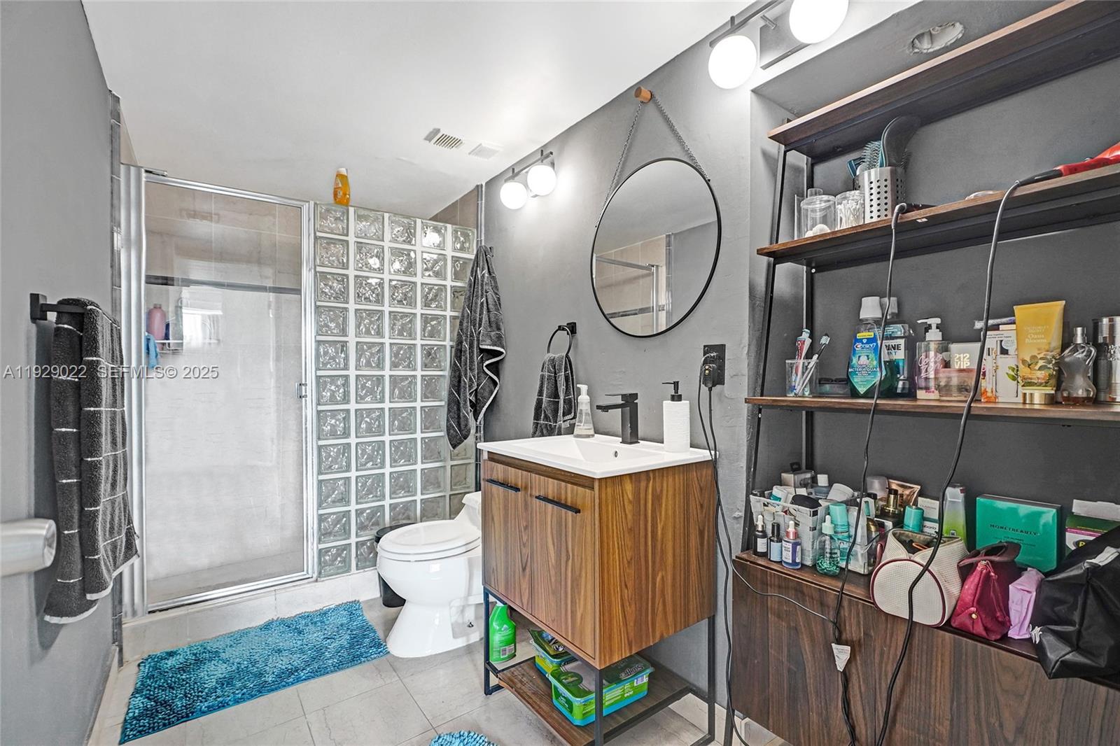 600 Northeast 36th Street, Unit 218 Miami, FL 33137 - Photo 10 of 31 a bathroom with a sink a toilet and shower