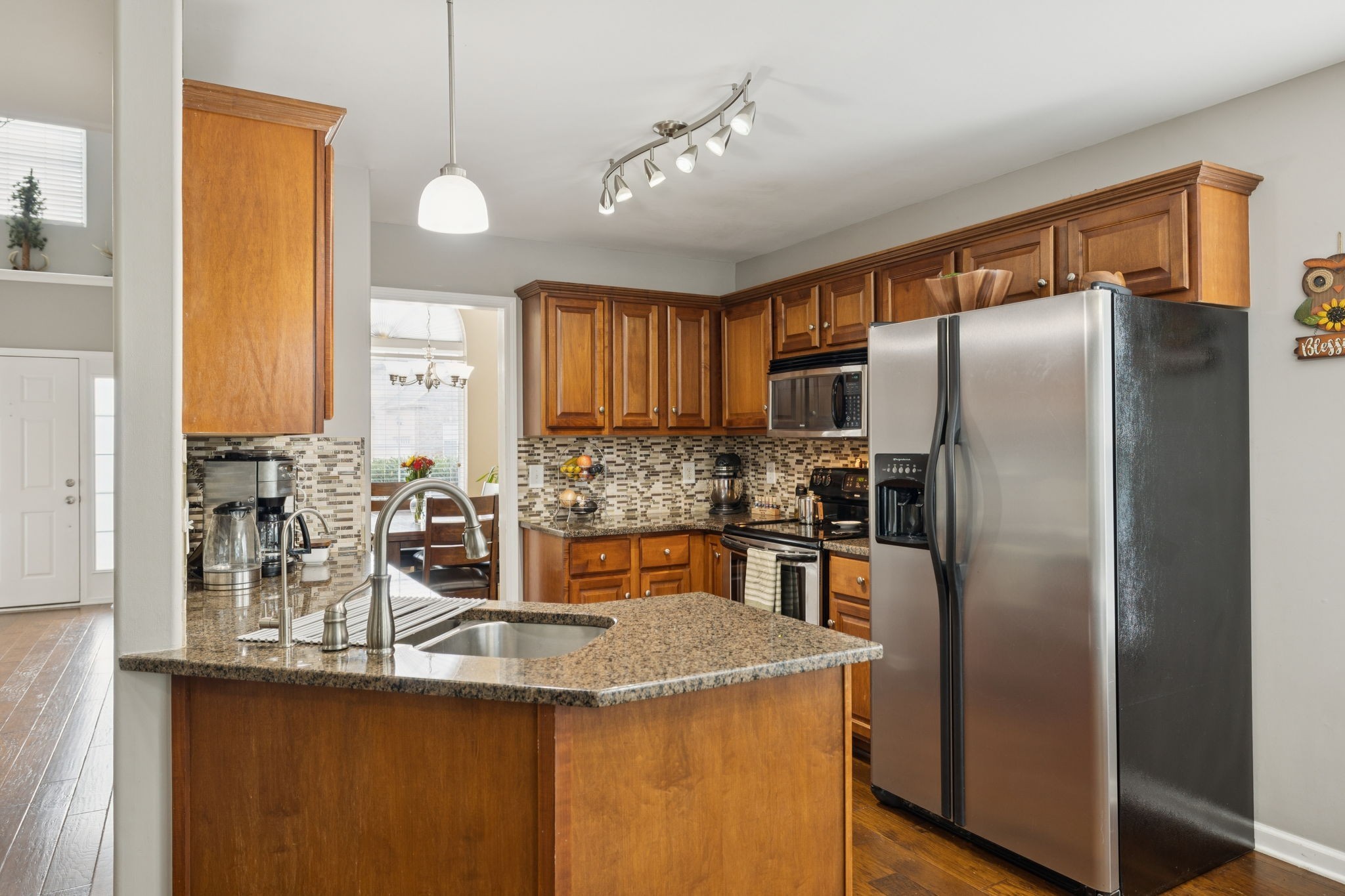 1062 Golf View Way Spring Hill, TN 37174 - Photo 12 of 42 a kitchen with stainless steel appliances granite countertop a refrigerator a sink a stove and island