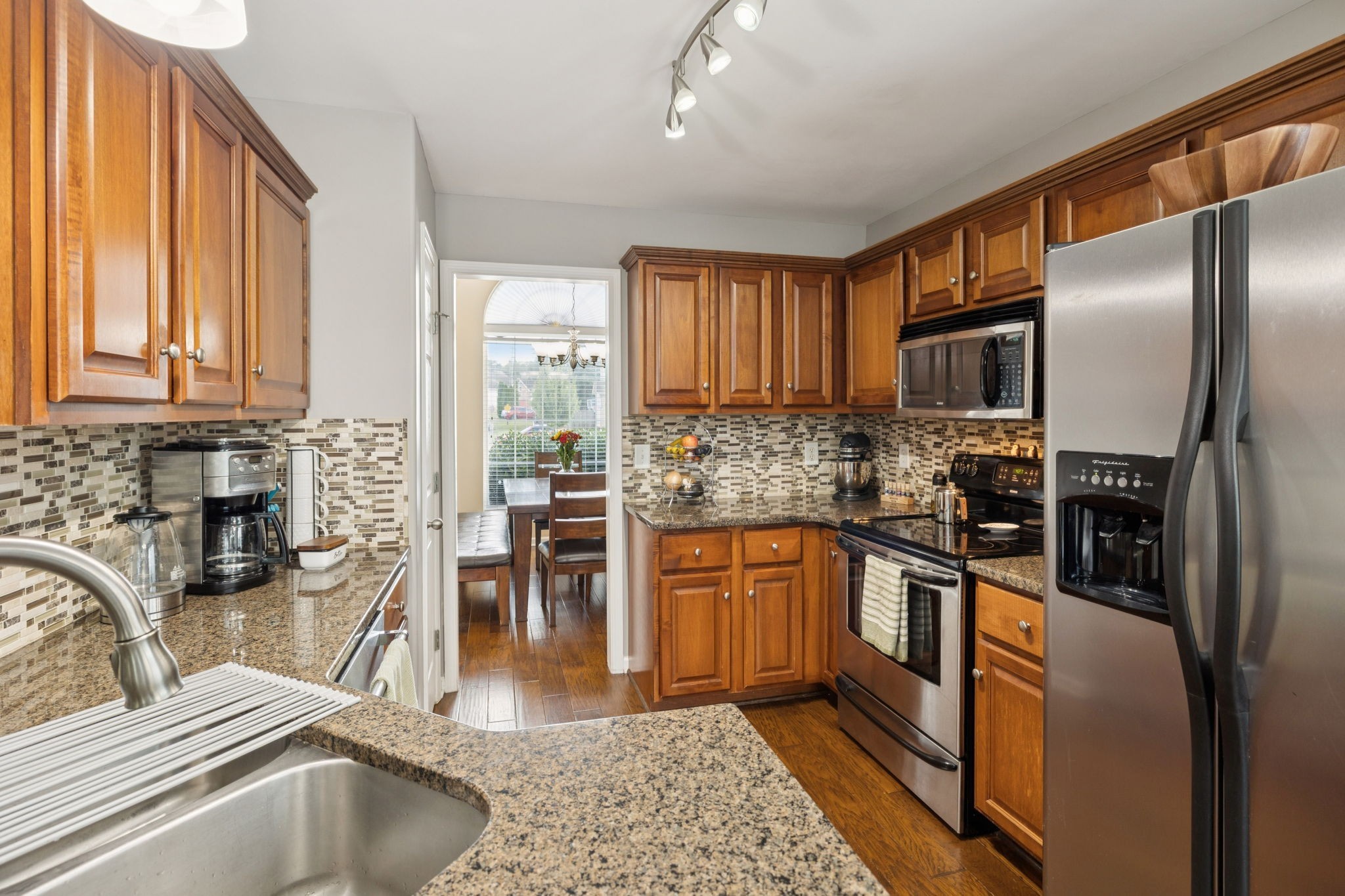 1062 Golf View Way Spring Hill, TN 37174 - Photo 14 of 42 a kitchen with stainless steel appliances granite countertop a refrigerator sink and stove