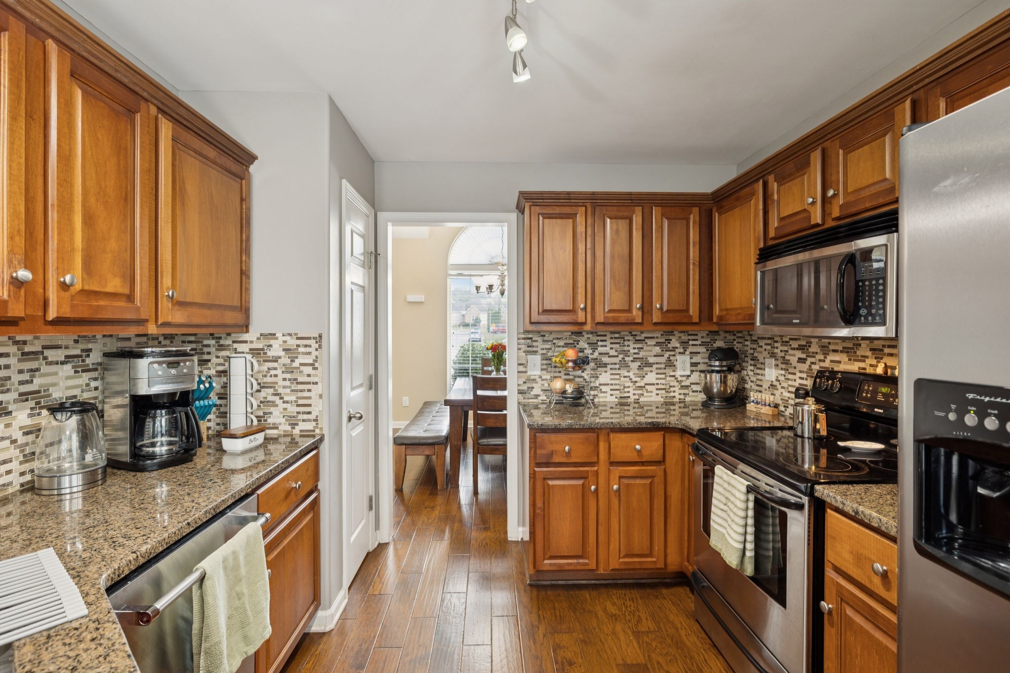 1062 Golf View Way Spring Hill, TN 37174 - Photo 15 of 42 a kitchen with stainless steel appliances a sink a stove top oven a counter space and cabinets