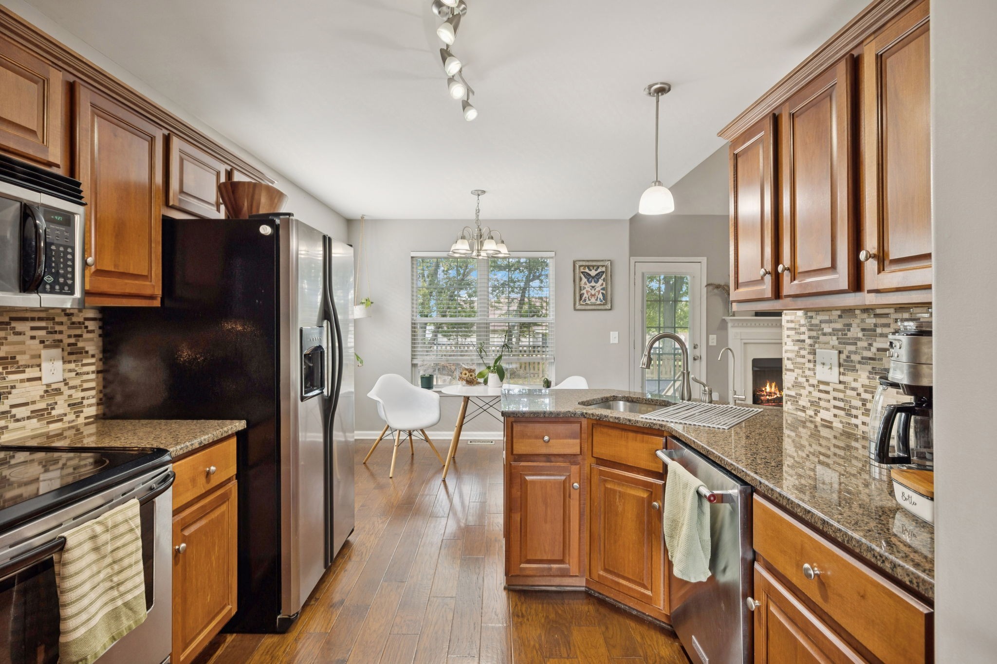 1062 Golf View Way Spring Hill, TN 37174 - Photo 17 of 42 a kitchen with granite countertop a sink appliances cabinets and counter space