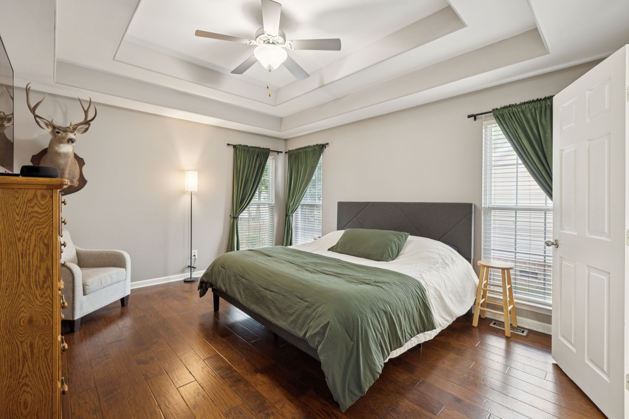 1062 Golf View Way Spring Hill, TN 37174 - Photo 21 of 42 a bedroom with a bed and a chandelier