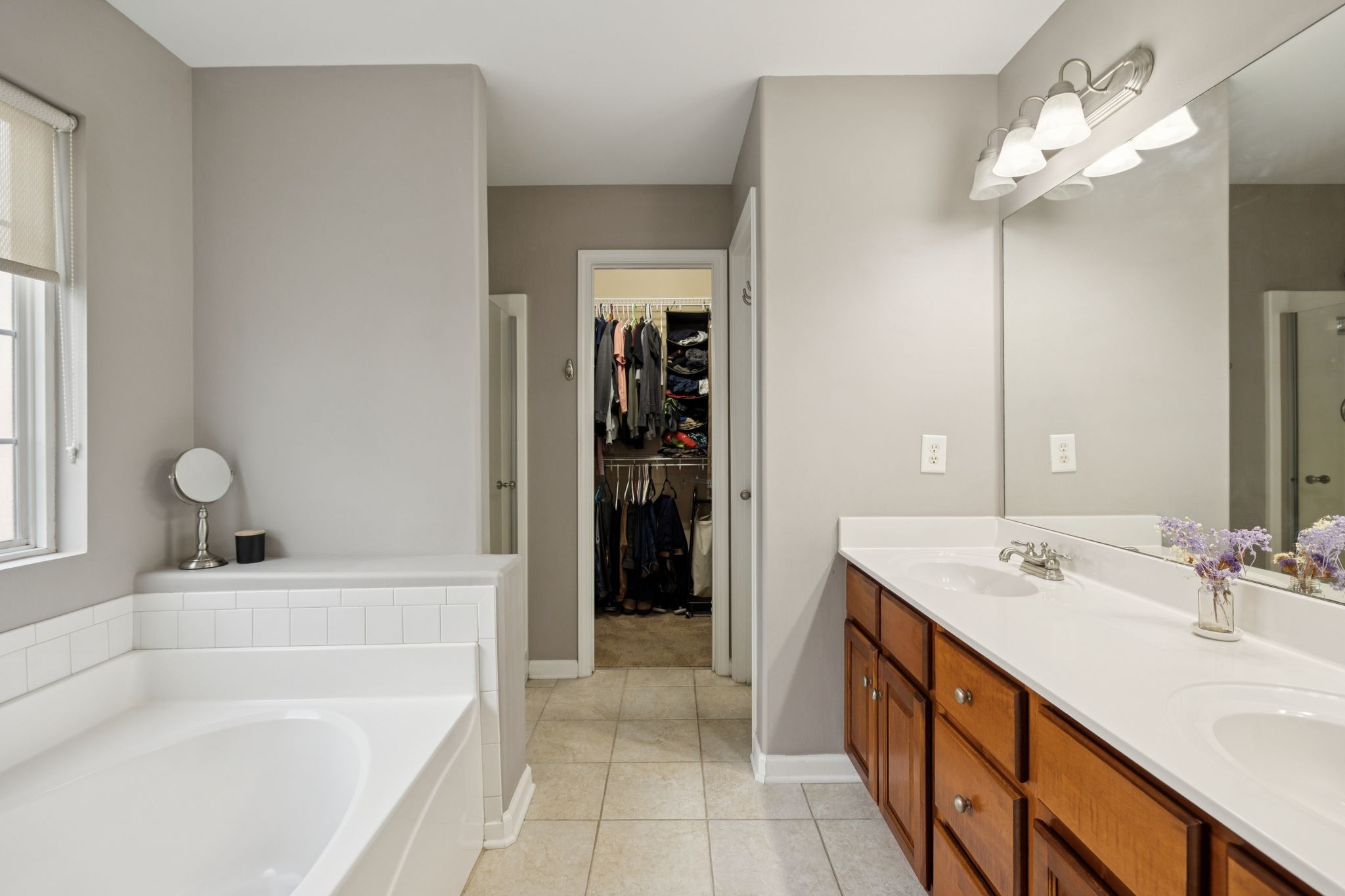 1062 Golf View Way Spring Hill, TN 37174 - Photo 24 of 42 a bathroom with a tub a sink and a large mirror