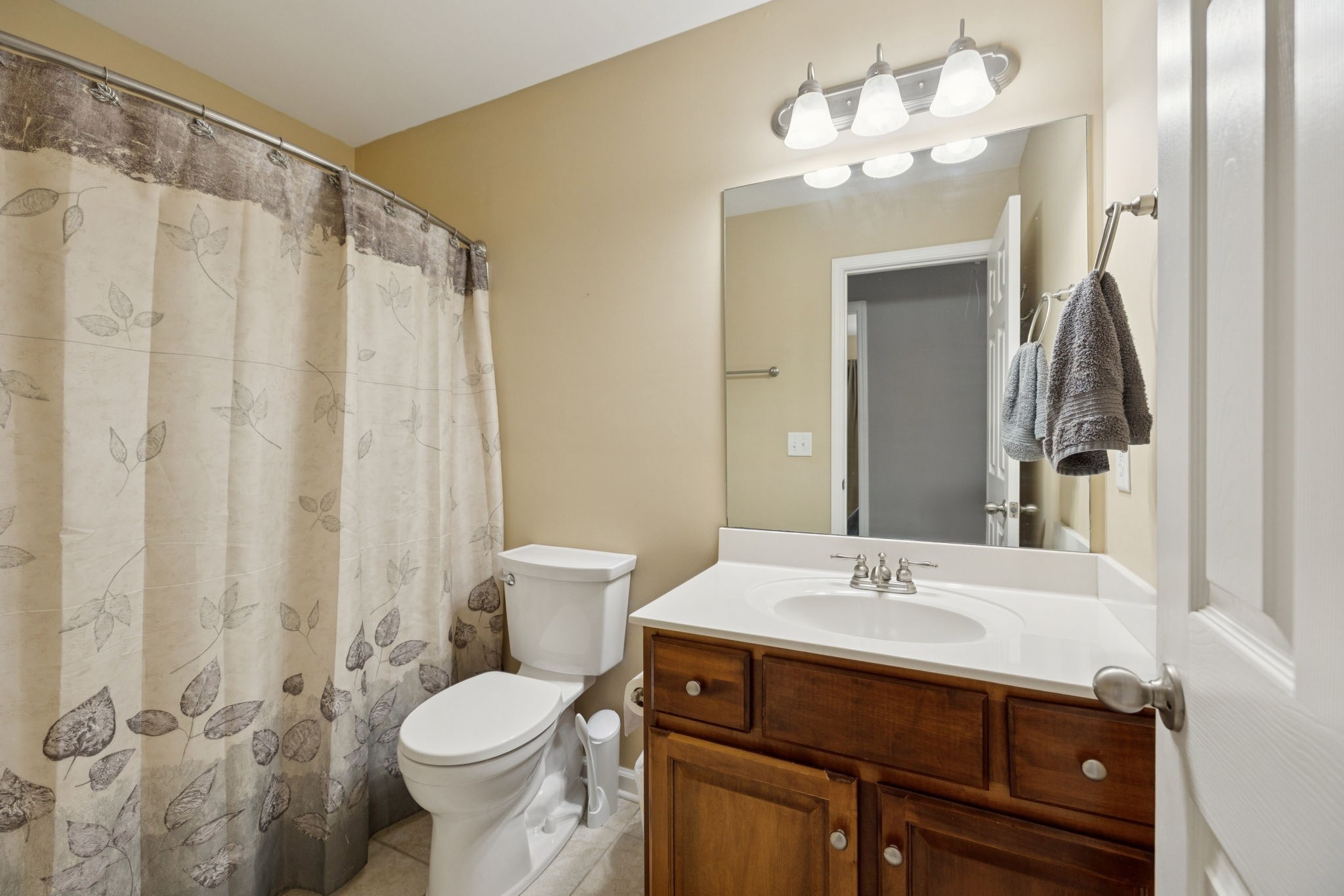 1062 Golf View Way Spring Hill, TN 37174 - Photo 31 of 42 a bathroom with a sink vanity mirror and toilet