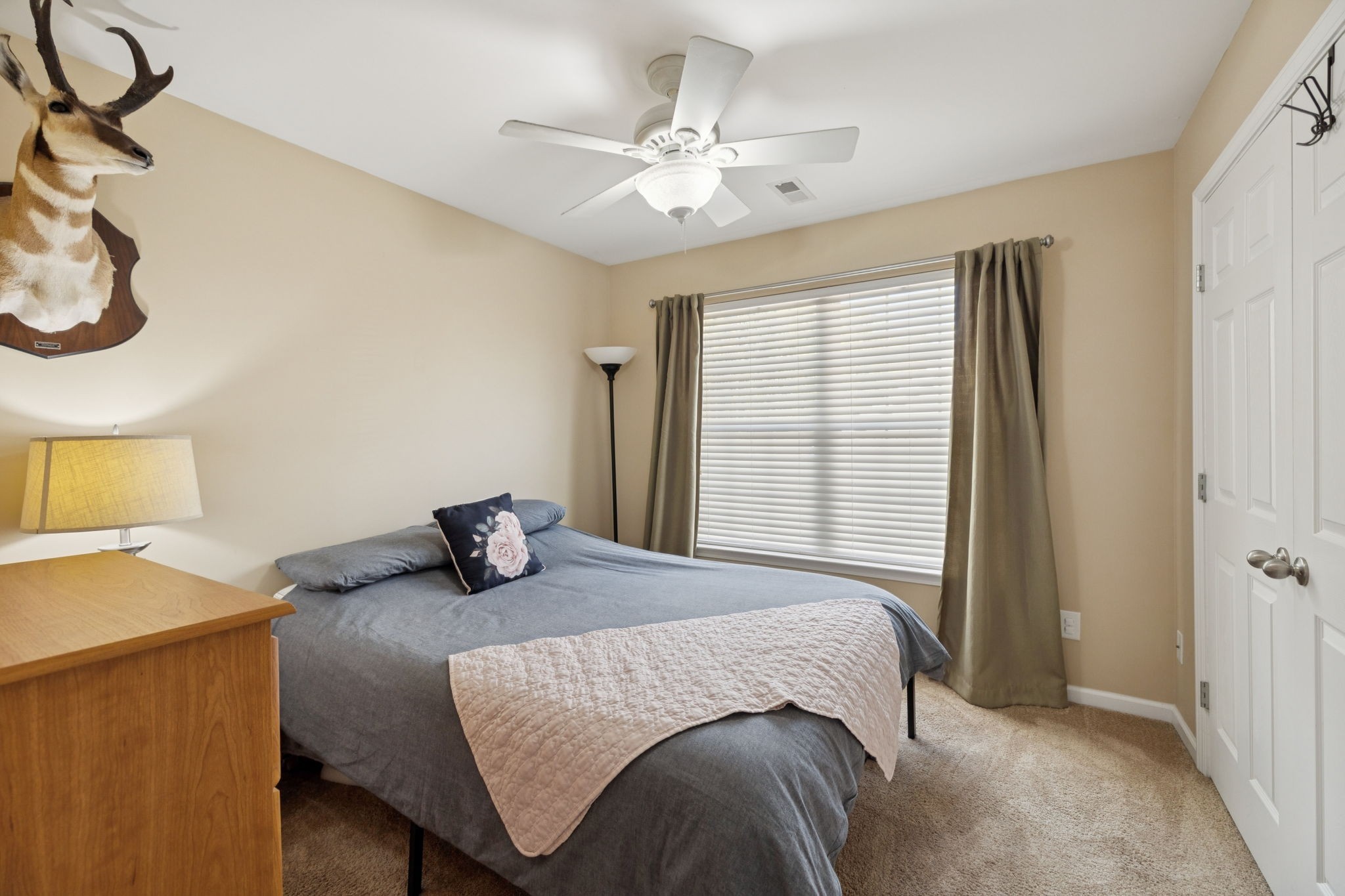 1062 Golf View Way Spring Hill, TN 37174 - Photo 32 of 42 a bedroom with a bed and a chandelier