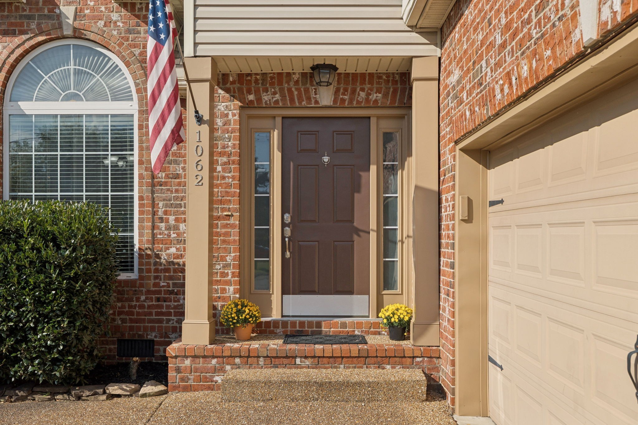 1062 Golf View Way Spring Hill, TN 37174 - Photo 5 of 42 a front view of a house with a garden