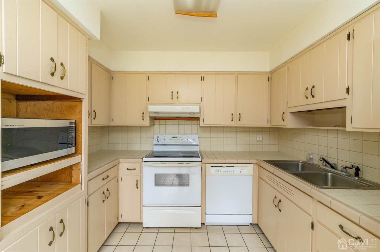 286 Barbertown Point Breeze Road Frenchtown, NJ 08825 - Photo 11 of 36 a kitchen with white cabinets appliances and a sink