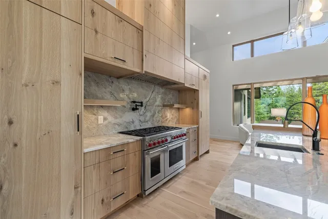 a kitchen with stainless steel appliances granite countertop a stove and a refrigerator