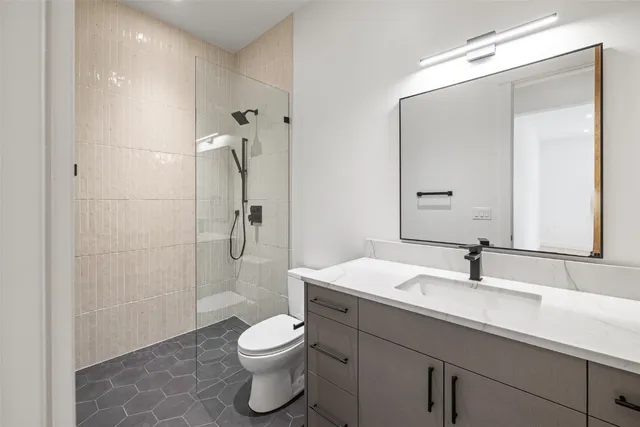 a bathroom with a sink toilet and shower