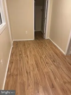 a view of a room with wooden floor and storage