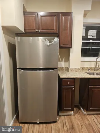 a close view of a refrigerator and cabinets