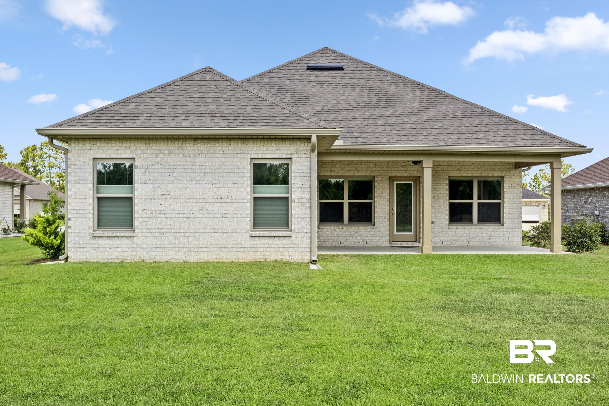 9868 Lakeview Drive Foley, AL 36535 - Photo 9 of 30 Rear view of house with a patio area and a yard