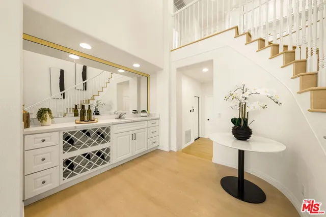 a bathroom with double vanity sink a mirror and a shower
