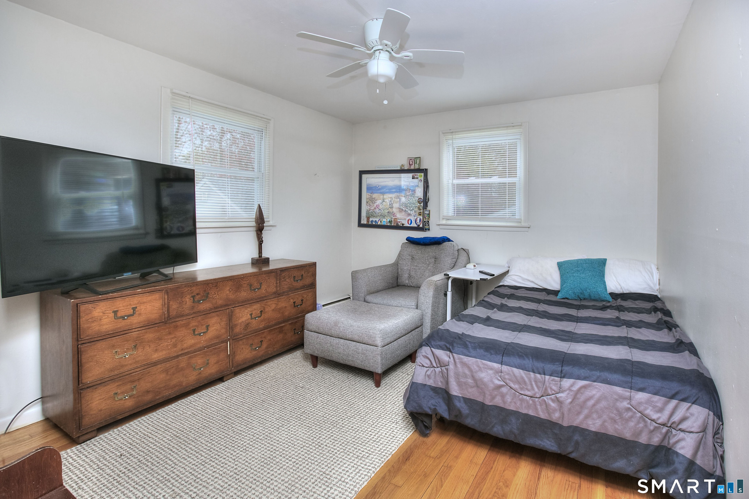 84 Youngstown Road Fairfield, CT 06824 - Photo 16 of 36 a bedroom with furniture and a flat screen tv
