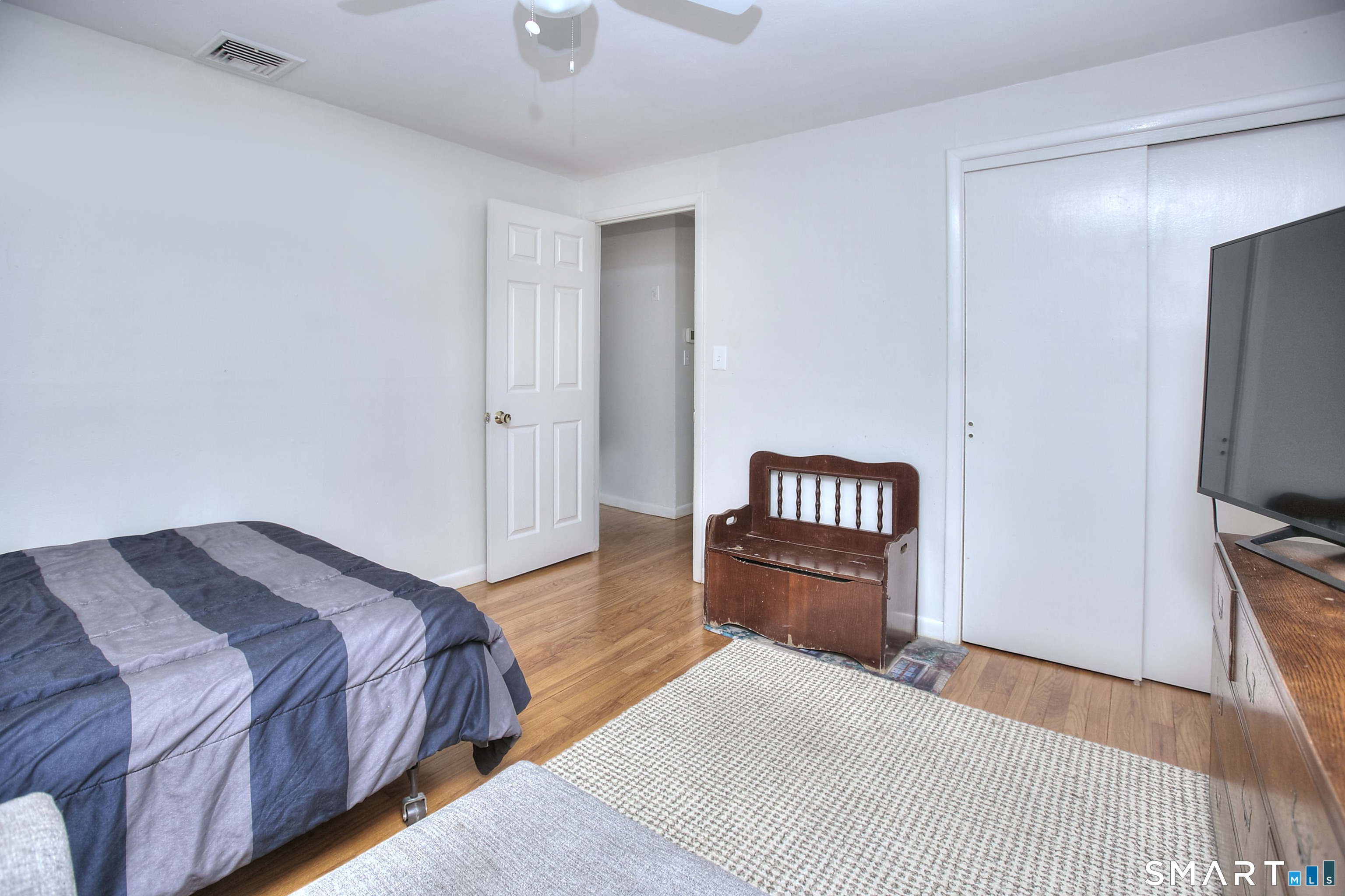 84 Youngstown Road Fairfield, CT 06824 - Photo 17 of 36 a bedroom with a bed and a flat screen tv