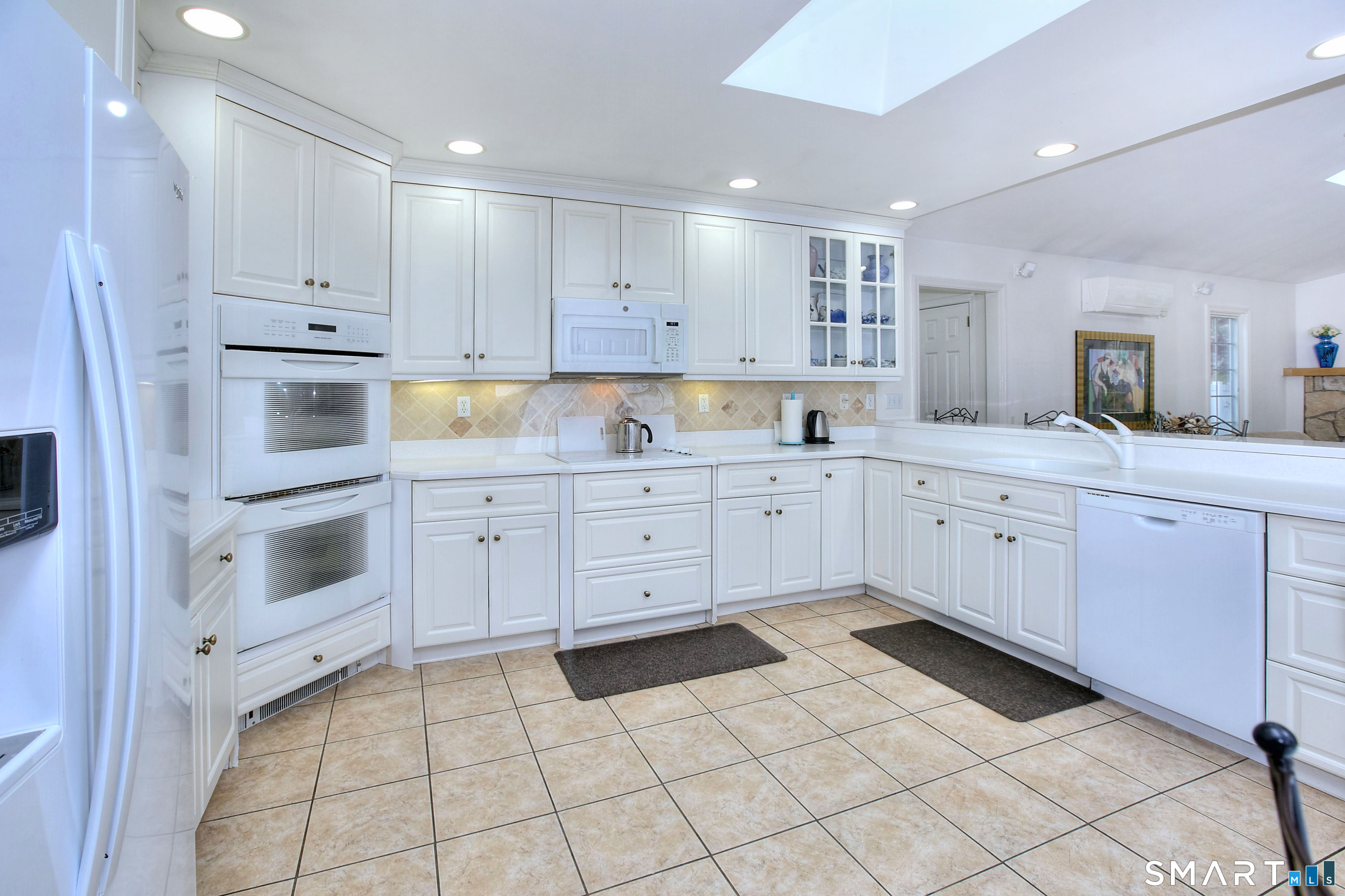 84 Youngstown Road Fairfield, CT 06824 - Photo 2 of 36 a kitchen with white cabinets and white appliances