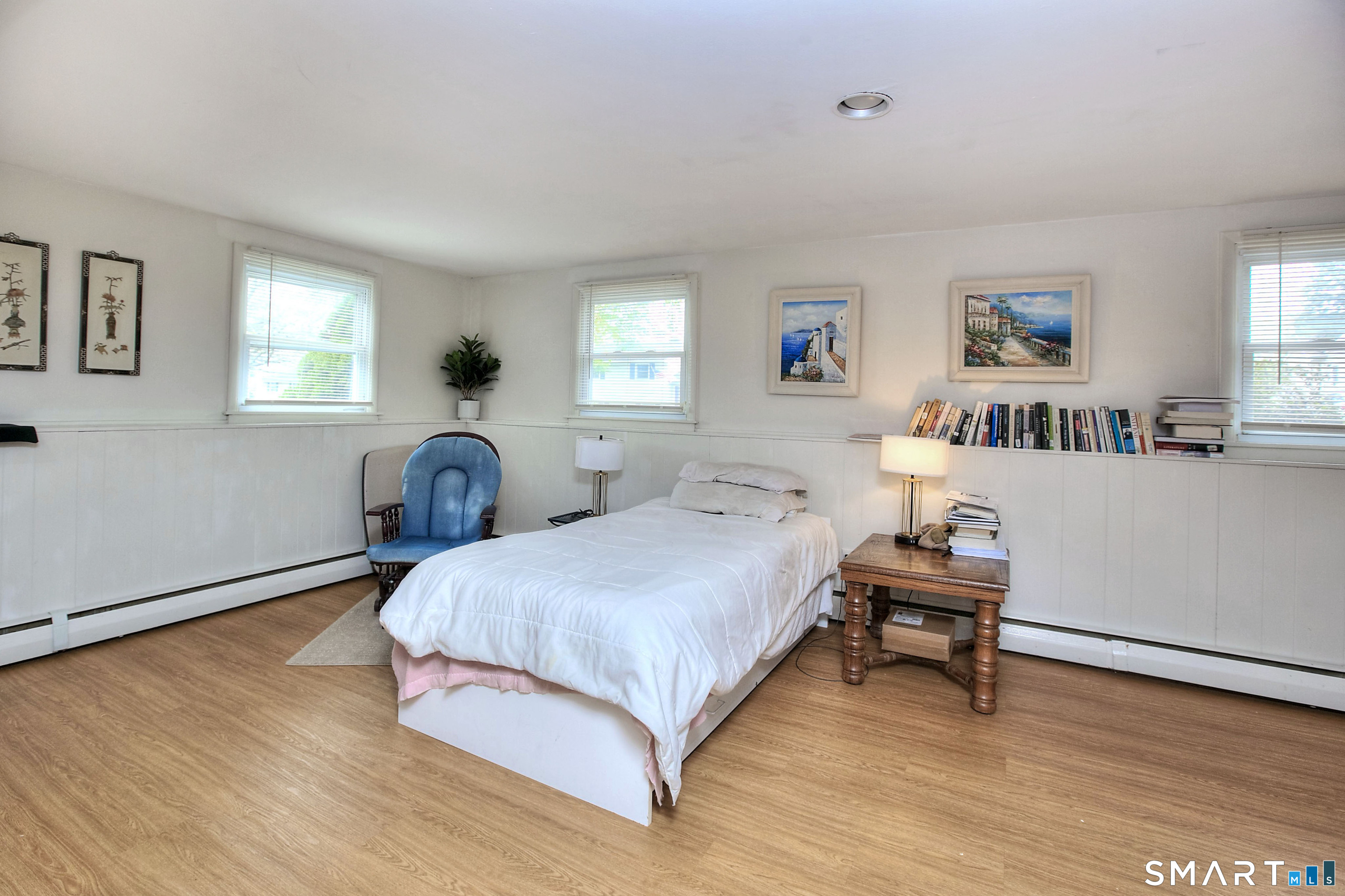 84 Youngstown Road Fairfield, CT 06824 - Photo 25 of 36 a spacious bedroom with a bed and a table in it