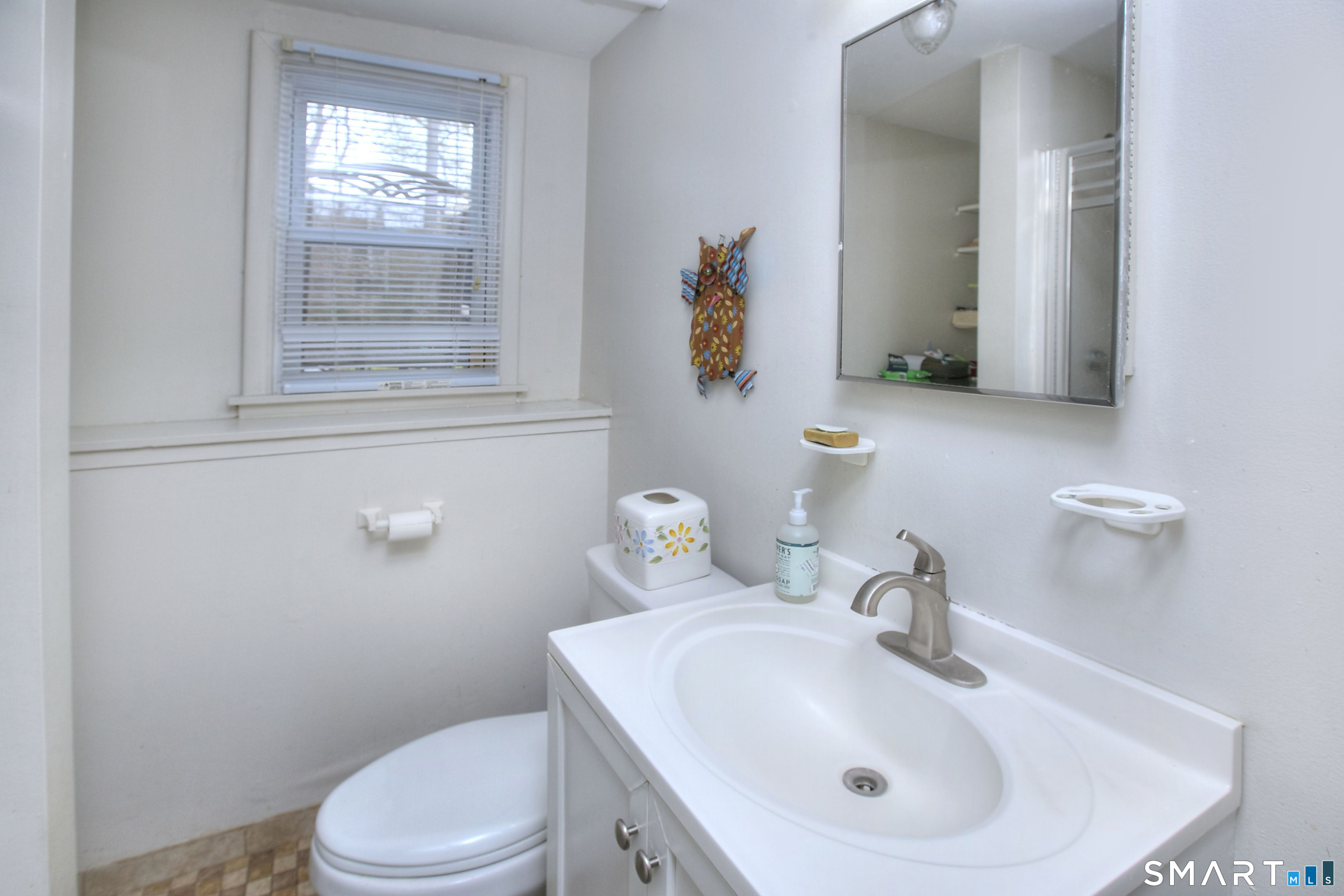 84 Youngstown Road Fairfield, CT 06824 - Photo 26 of 36 a bathroom with a toilet sink and mirror