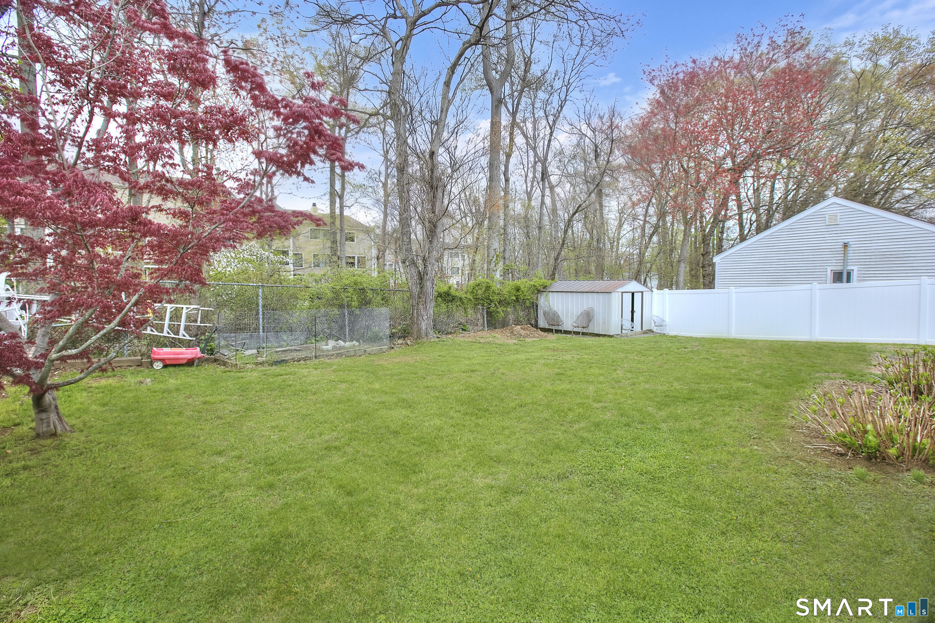 84 Youngstown Road Fairfield, CT 06824 - Photo 28 of 36 a view of a house with backyard and a tree