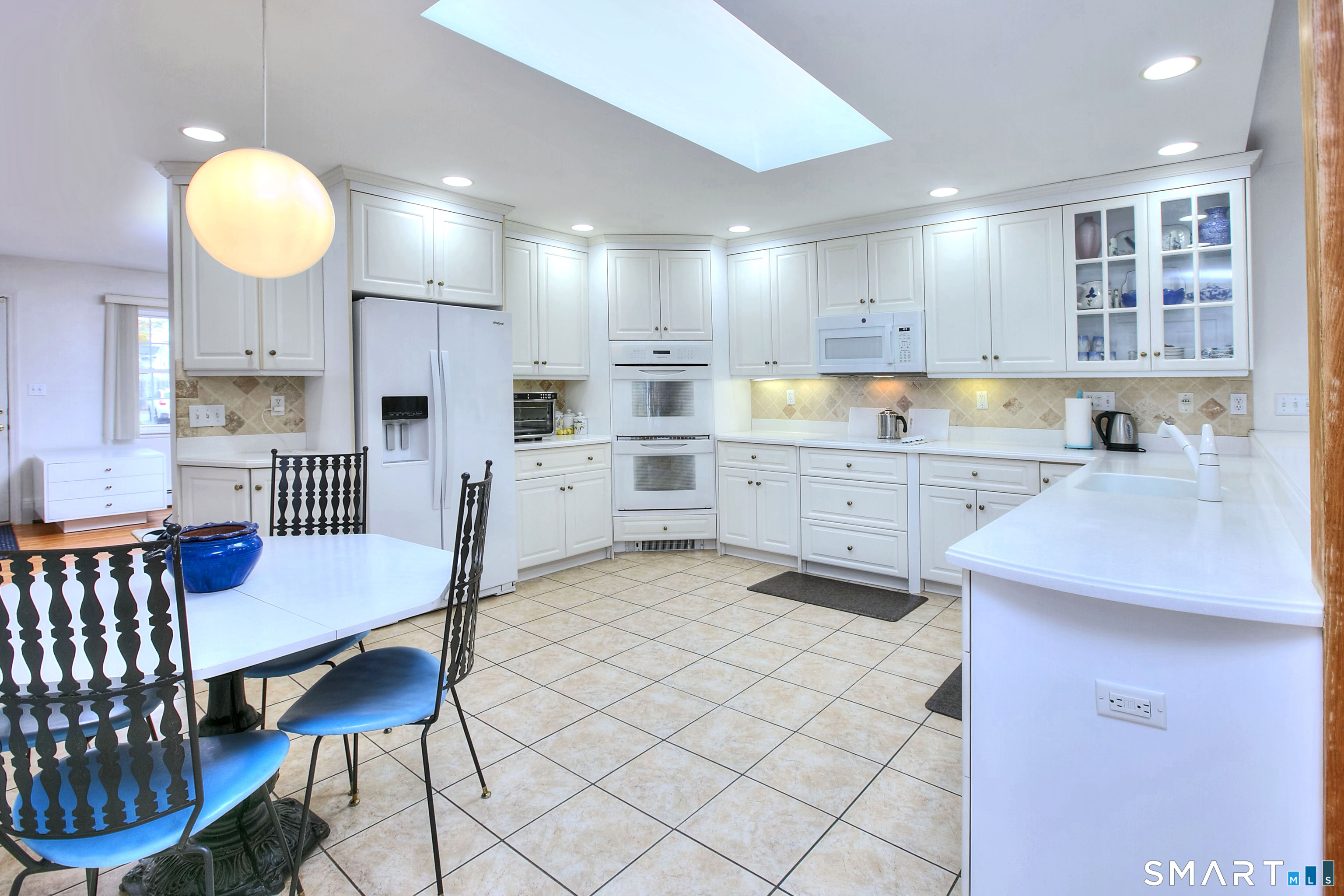 84 Youngstown Road Fairfield, CT 06824 - Photo 3 of 36 a kitchen with a dining table chairs and view kitchen