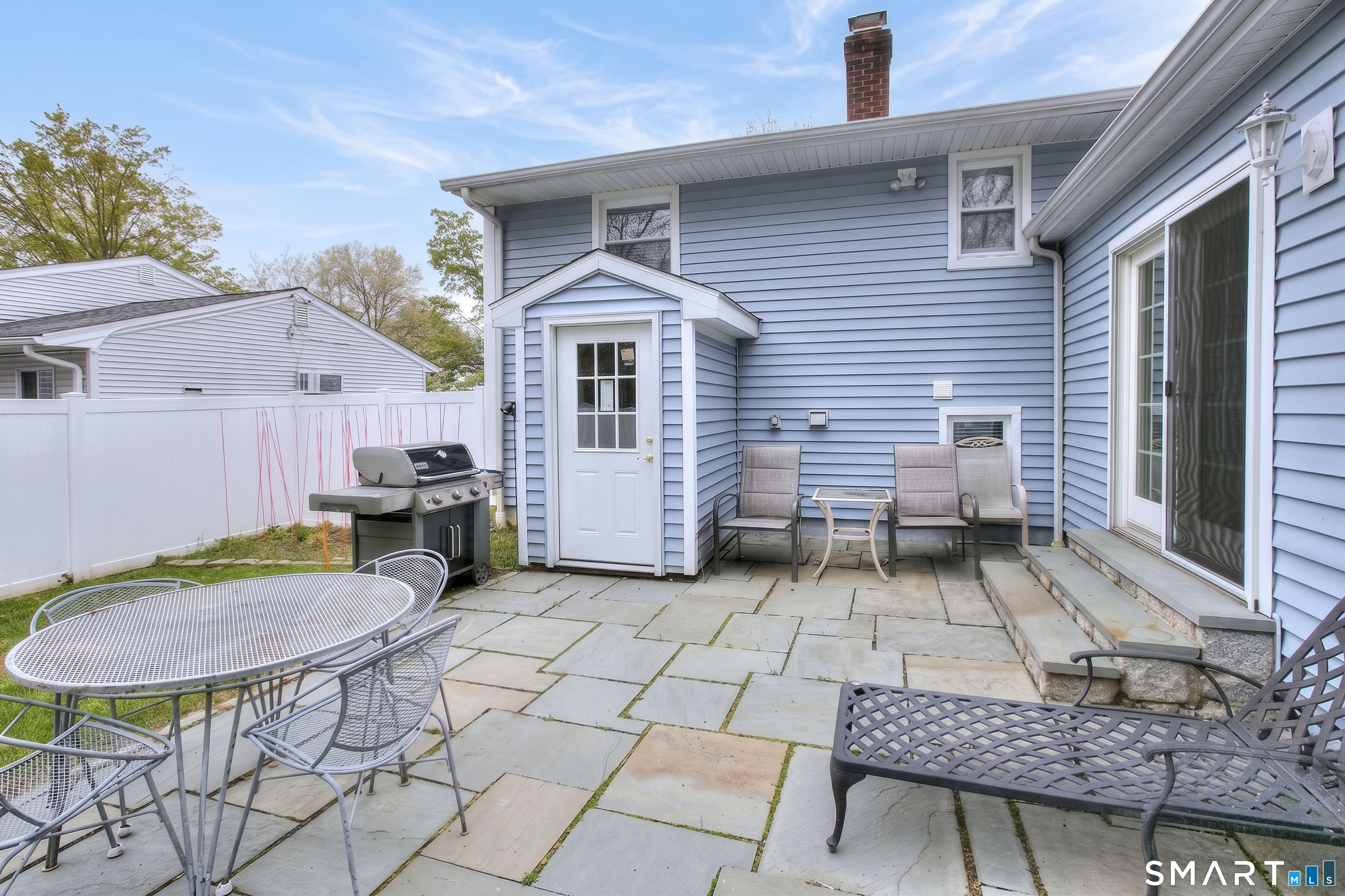 84 Youngstown Road Fairfield, CT 06824 - Photo 31 of 36 a view of a chairs and table in backyard of the house